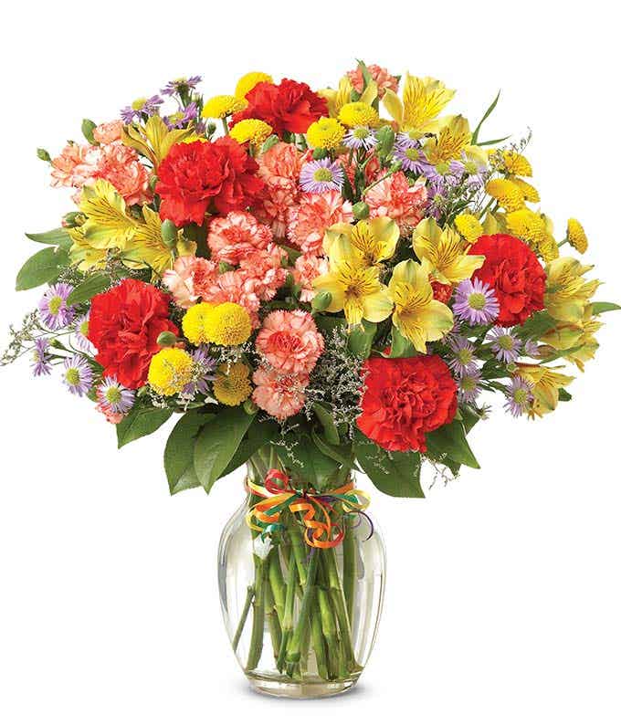 Warm Floret - This arrangement includes Colorful Carnation Variety Alstroemeria & Button Poms