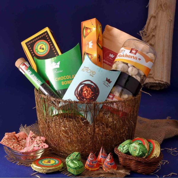 A Complete Delicacy Hamper with Chocolate Almond Rocks , Tomato Multigrain Lavash, Exotic Jasmine Tea Tube , Chocolate Bomb, Chocolate Chakri & other things in it