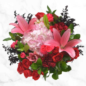 Passion Vase Arrangement using a combination of spray roses, lilies , hydrangeas, carnations and greenery.