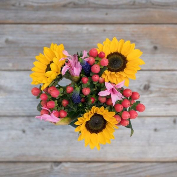 Teacher’s Pet Bouquet composed of sunflowers and baby pink lilies.