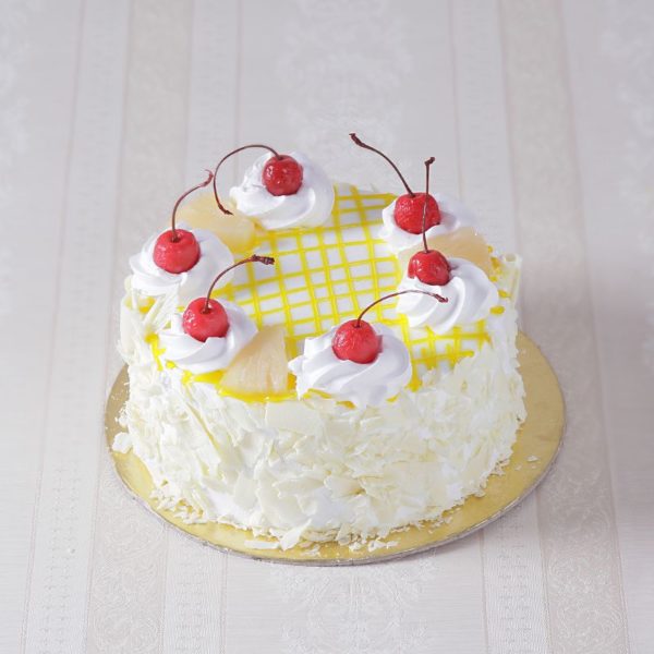 Eggless Pineapple Fresh Cream Cake with some great design on it