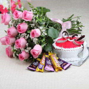 Bunch of Pink Roses with Matching Ribbon Bow Tied and Round Shape Strawberry Cake along with 5 Bars of Assorted Chocolate