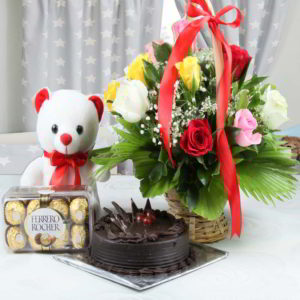 Mix Roses Round Handle Basket Arrangement, White Teddy Bear, Ferrero Rocher Chocolate Box along with Round Truffle Chocolate Cake.